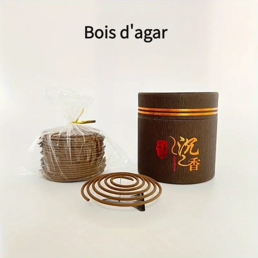 Une boîte de bobine d'encens au bois d'agar avec un pack de spirales dont une posée sur un socle