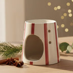 Un Diffuseur Cire Rayé Rouge Scentchips  sur une table vu de trois quarts