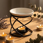 Brûleur d'arômes design courbe noir métal et céramique blanche sur surface bois