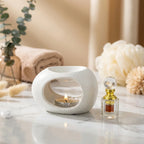 Diffuseur huiles essentielles céramique artisanal blanc avec bougie, style épuré luxe
