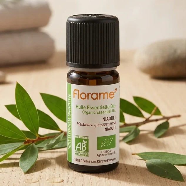 Huile essentielle Bio Niaouli 10ml Florame avec feuilles de niaouli sur surface en bois