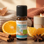 Huile essentielle Cannelle-Orange bio Florame 10ml entourée d'oranges et bâtons de cannelle