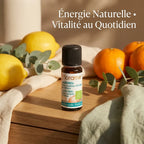 Flacon d'huile essentielle Florame agrumes bio 10ml entouré de citrons frais et eucalyptus sur vanity wellness