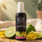 Spray Bergamote Ylang-Ylang 100ml entouré de fleurs et tranches de citron vert